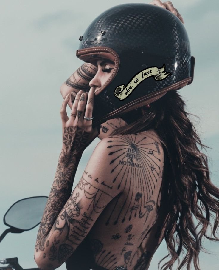 Rider in an open-face helmet, tattooed, beside a machine